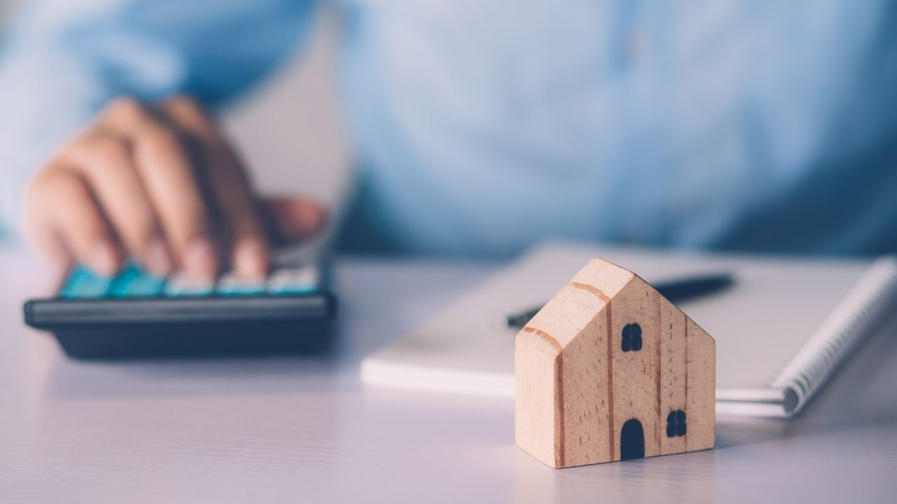 calculator,%20mortgage%20papers,%20and%20a%20miniature
